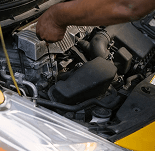 A mechanic performing vehicle maintenance